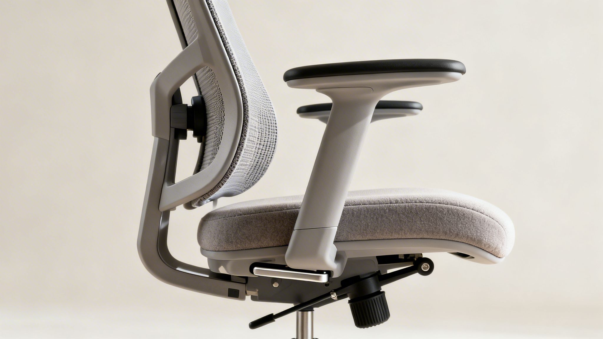 Side view of a modern light grey ergonomic office chair with mesh back and fabric seat.